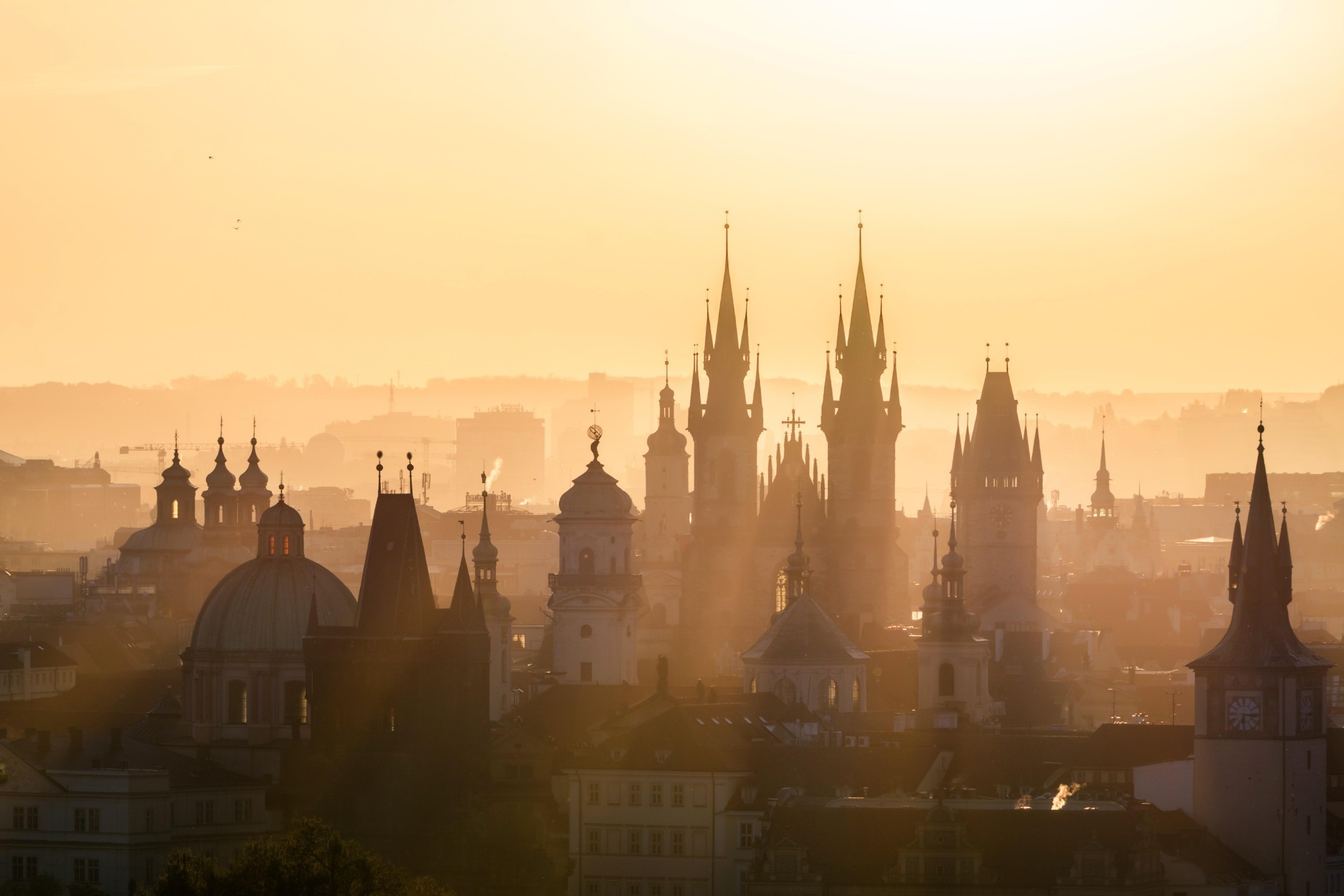 Prague Old Town spires in morning mist